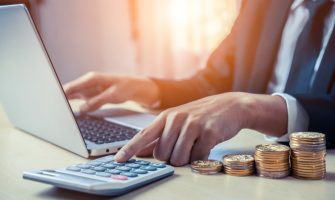 Businessman accountant or financial expert analyze business report graph and finance chart at corporate office. Concept of finance economy, banking business and stock market research.