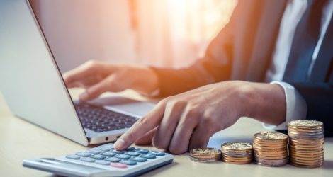 Businessman accountant or financial expert analyze business report graph and finance chart at corporate office. Concept of finance economy, banking business and stock market research.