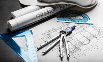 Construction planning drawings on black background